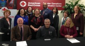 CRCC managing director Brie Loskota (far right) participates in a signing ceremony at the American Red Cross Disaster Operations Center.