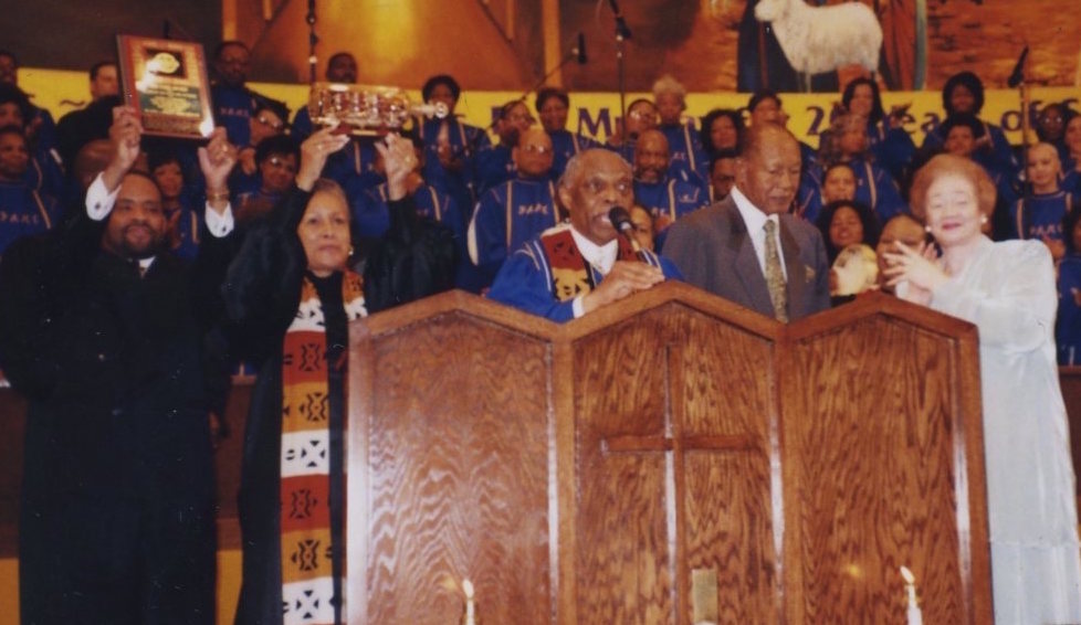 The Rev. Dr. Cecil Murray at the pulpit at First AME Church, Los Angeles, with Mayor Tom Bradley with Mayor Tom Bradley standing next to him