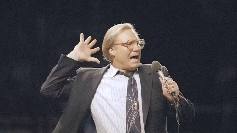Jimmy Swaggart holds mic