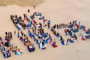 people arrange themselves to spell out 