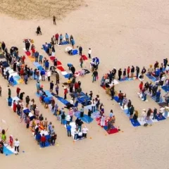 people arrange themselves to spell out 