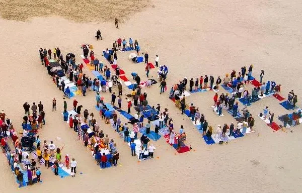 people arrange themselves to spell out 