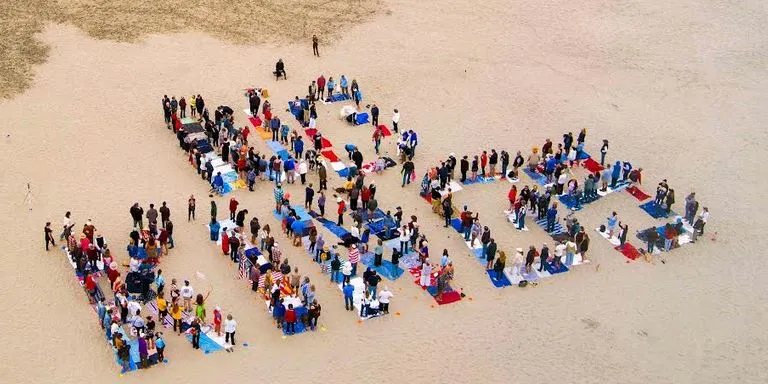 people arrange themselves to spell out 